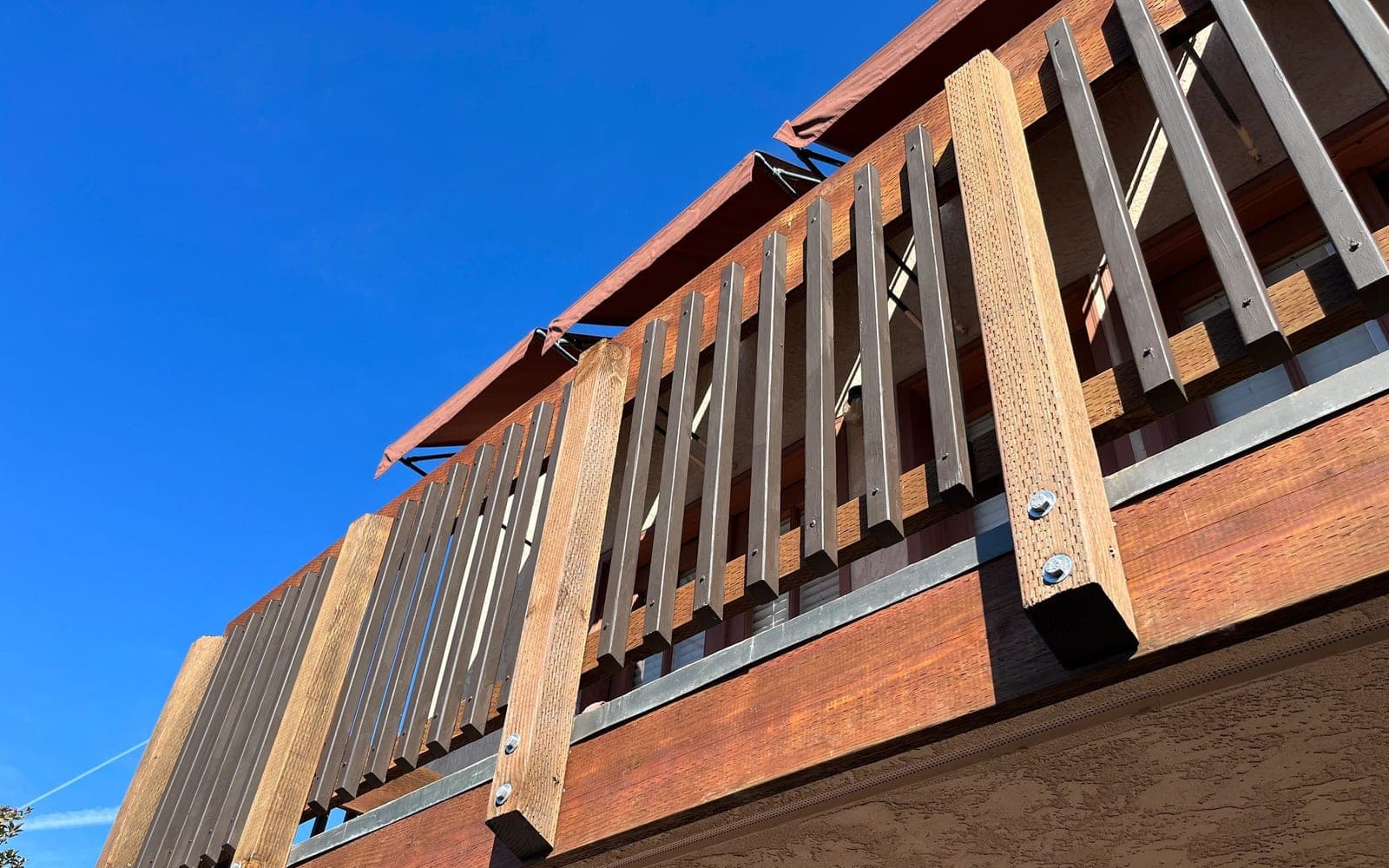 All World Construction balcony repair railing detail with finished wood and metal pickets